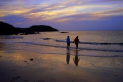 Guests enjoy a late evening paddle at Achmelvich beach