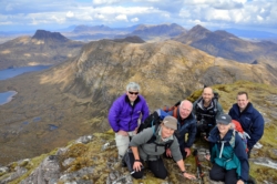 Members of Ullapool Hillwalking Club on Ben Mor Coigach enjoying the view of Inverpolly