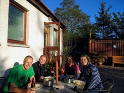 Guests relaxing in the evening sun after a hard day cycling the NC500